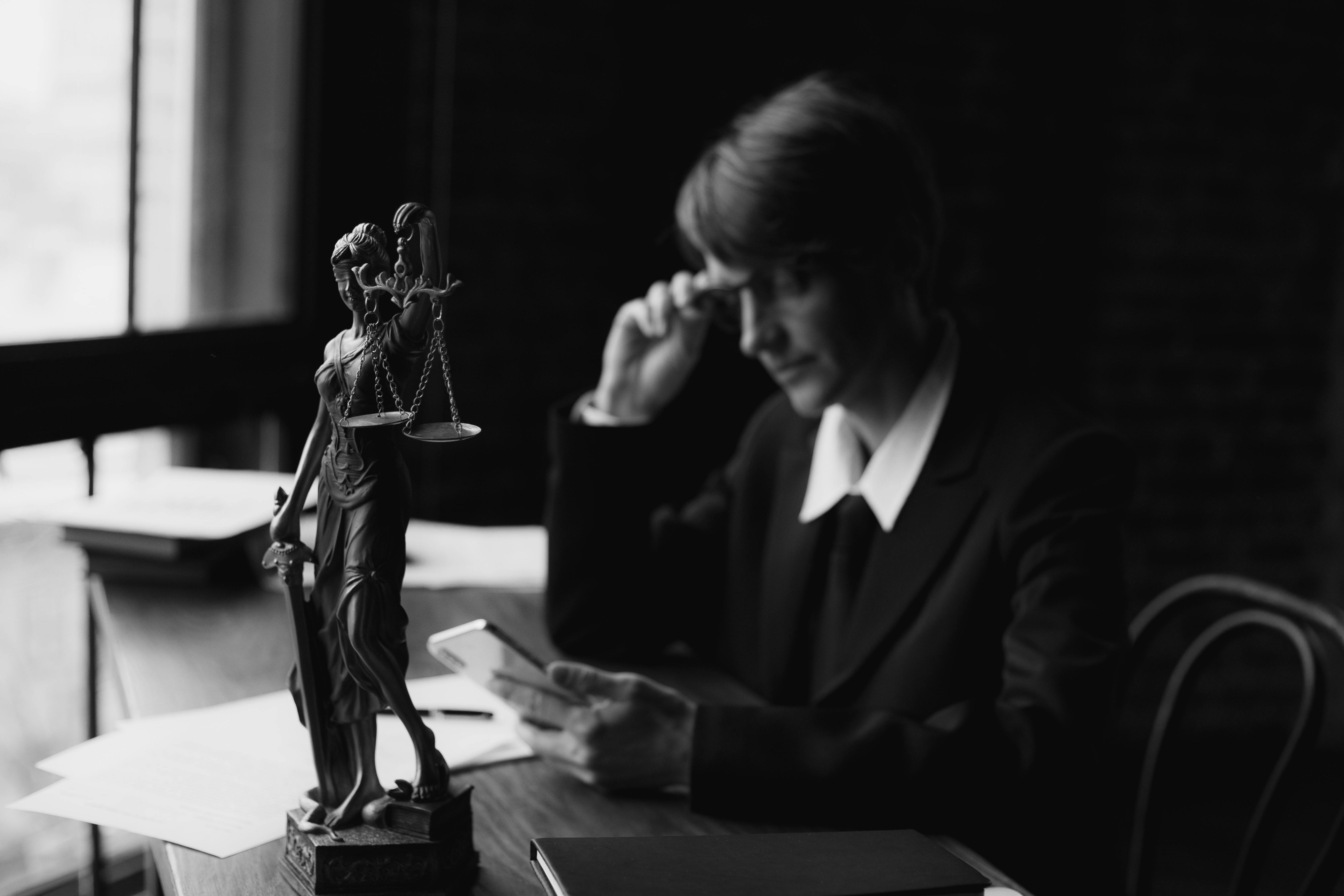 Lady justice statue with legal materials