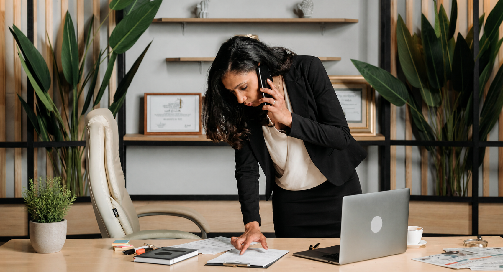 Lawyer reviewing documents while on a phone call